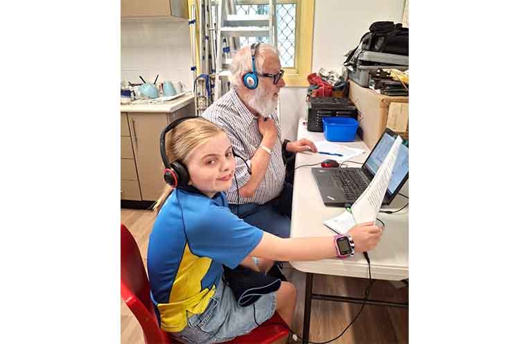 Amateur Radio Club member Graham Moss with a Junior Girl Guide.