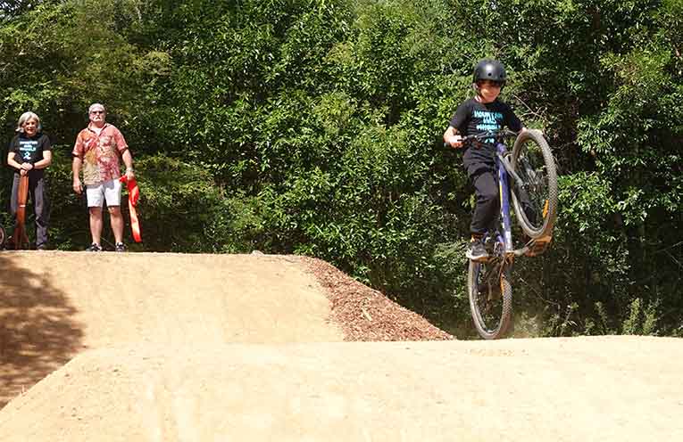 Mayor Nikki Williams and Dave Dunn watch a local rider get some air.