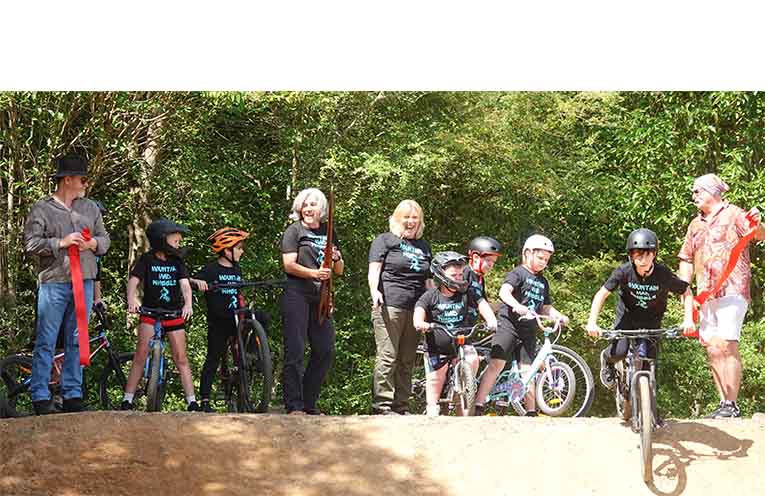 Mayor Nikki Williams (centre, left) and Eastern Dorrigo Community Hall & Showground Facility Management Committee Chair Carole Cleary send the riders on their way at the official opening of the Ulong BMX track.