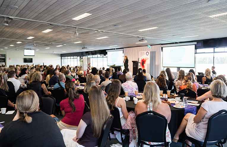 Keynote speaker Kate Toon on stage.