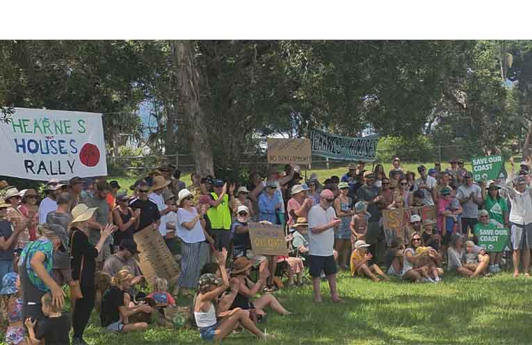 A vocal crowd gathers for the protest at Sandy Beach Reserve.