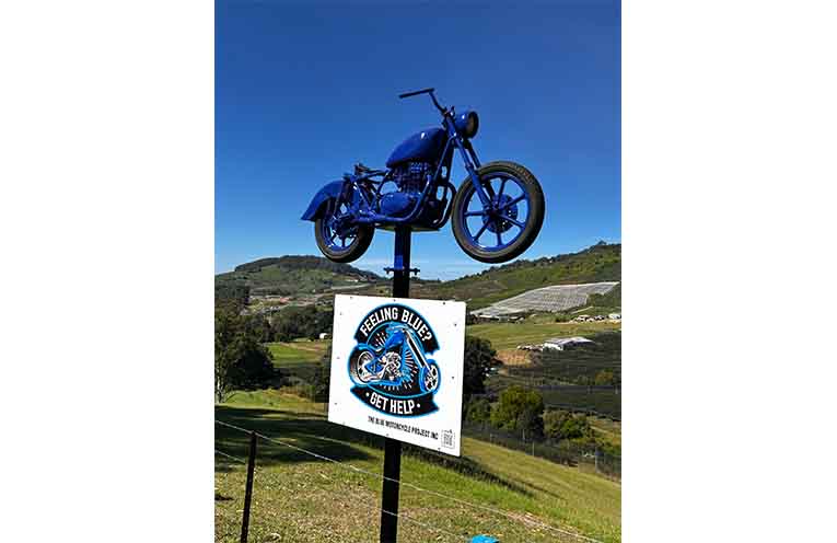 The eye-catching Blue Motorcycle on Red Hill.