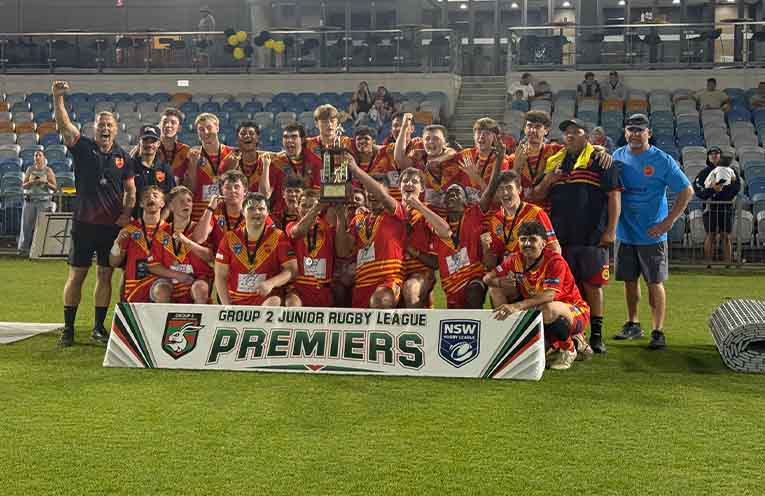 The Coffs Harbour Comets under-16s celebrate their premiership win.