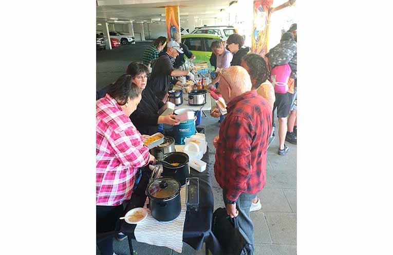Distributing food at the Park Avenue car park entry, Coffs Harbour. Photo: Sharon Jane