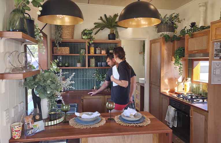 A couple inspecting an award-winning home by company Tiny Noosa. Photo: Jessica Miller.