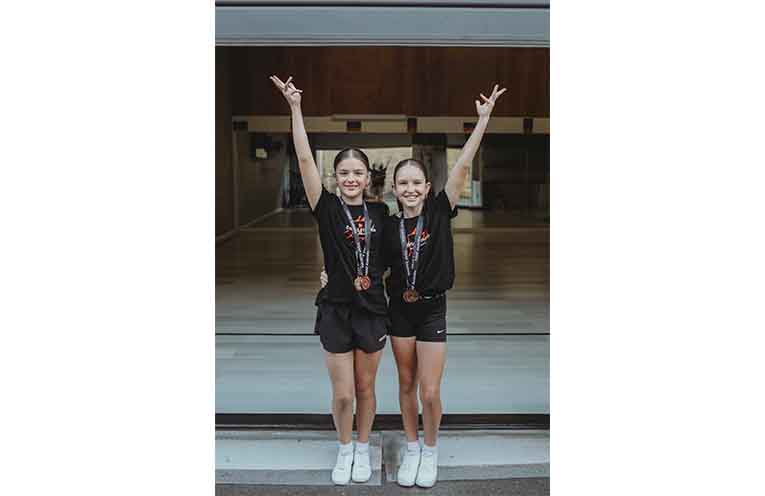 Harriet Rampling and Ella Gibson proudly display their bronze medals.