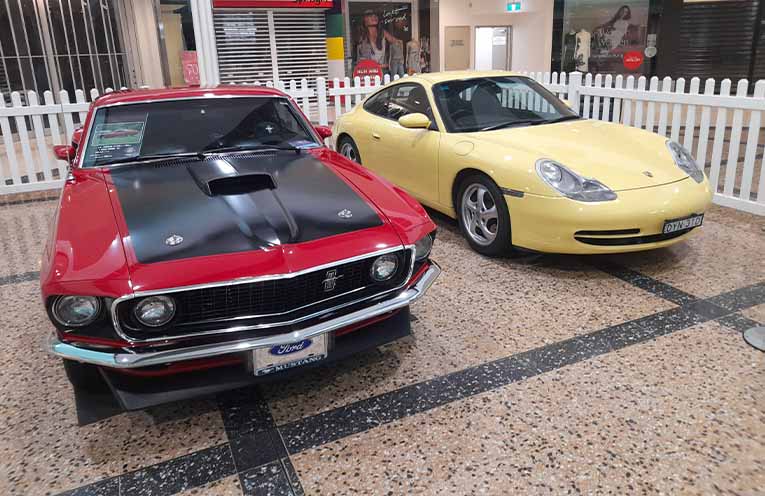 Display in Plaza Porsche 996 Carrera and 69 Mustang Fastback.
