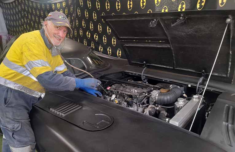 “Batman” (Mike Camilleri) fine-tuning the Batmobile for the Motor Show.